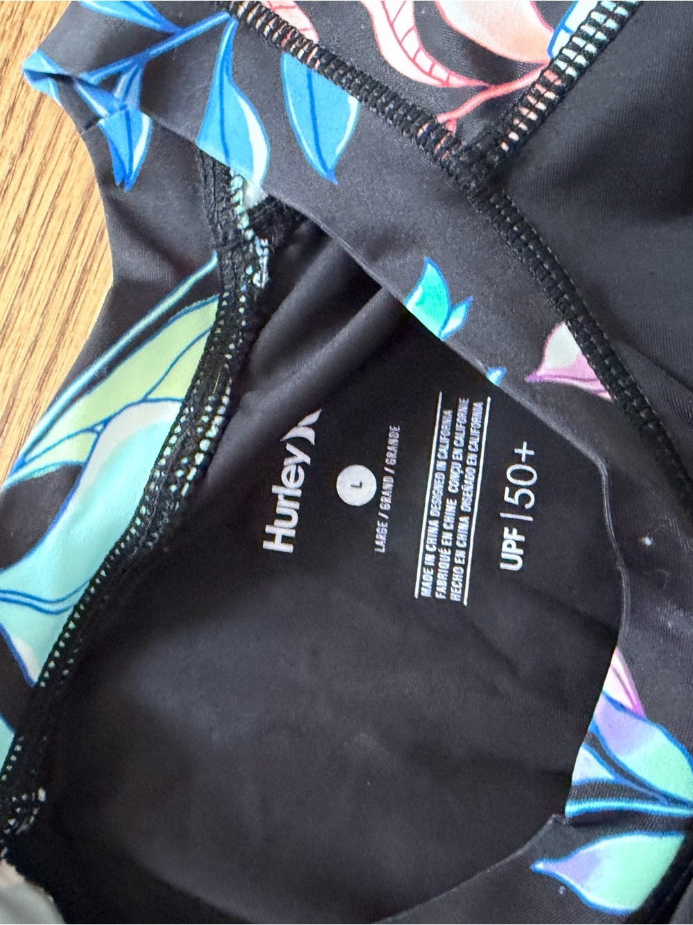 Hurley Black One-Piece Rash Guard with Blue and Pink Floral Accents - Picture 2 of 3